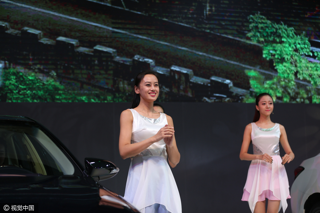 白衣车模笑容甜美。