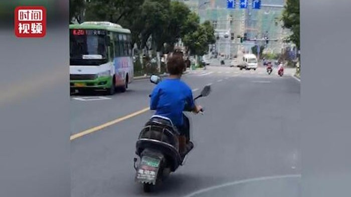 “蛇形走位”少年再次上路 电动车后座还带了俩小伙伴