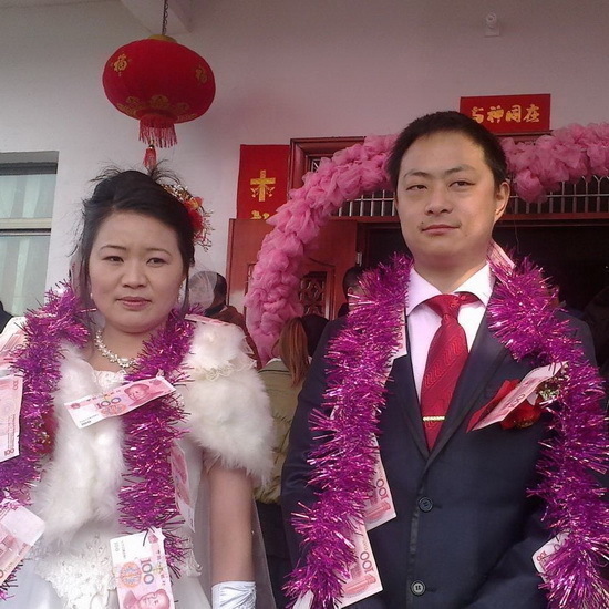 太土豪!河南新郎新娘身披百元大钞结婚