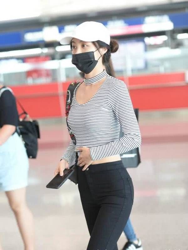 李菲儿现身机场,好好的衣服非要剪两个大洞,这